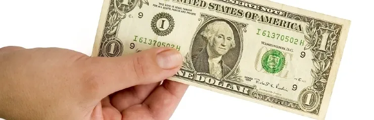 Hand holding a one-dollar bill.