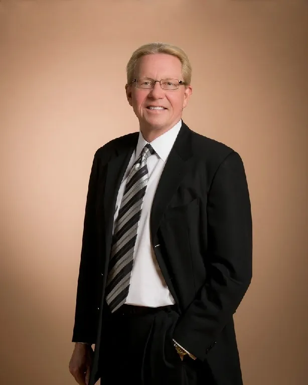 Man in suit with striped tie.